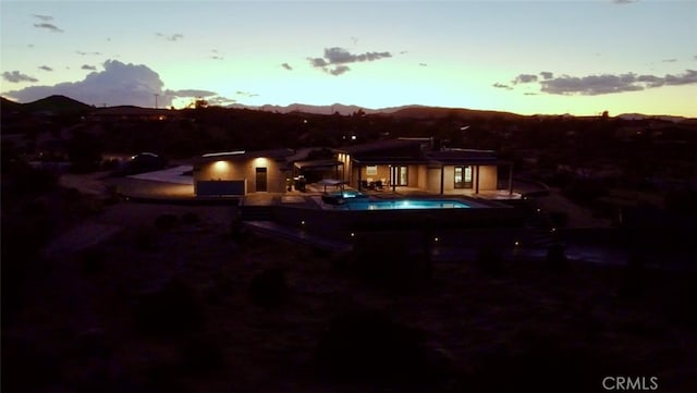 back house at dusk with a mountain view