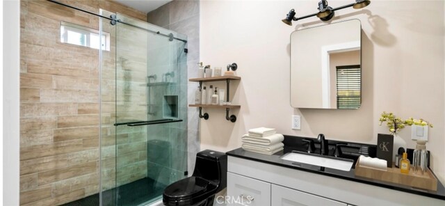 bathroom with toilet, walk in shower, and vanity