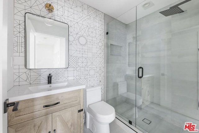 bathroom featuring tile walls, an enclosed shower, toilet, and oversized vanity