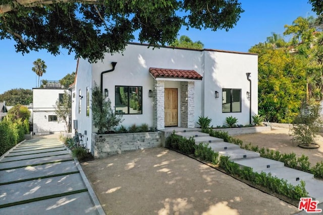 mediterranean / spanish-style house featuring a patio area