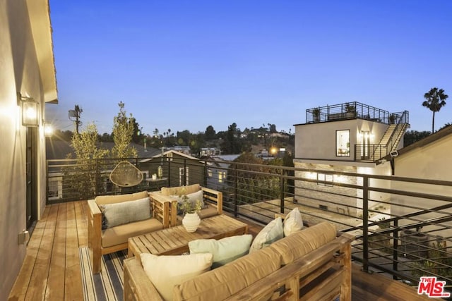 deck at dusk featuring outdoor lounge area