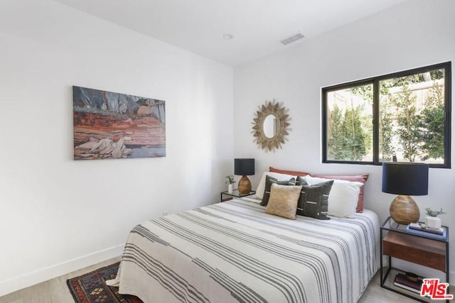 bedroom with light hardwood / wood-style floors