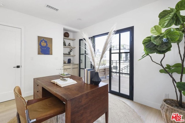 office space with light hardwood / wood-style flooring