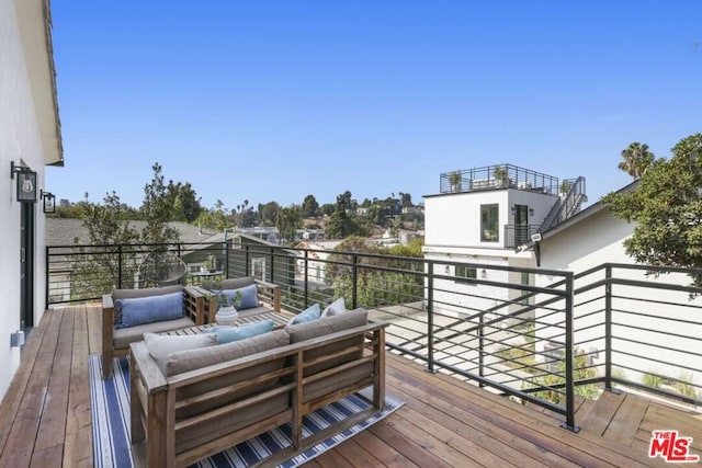 wooden terrace with outdoor lounge area