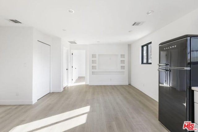 spare room featuring light hardwood / wood-style flooring