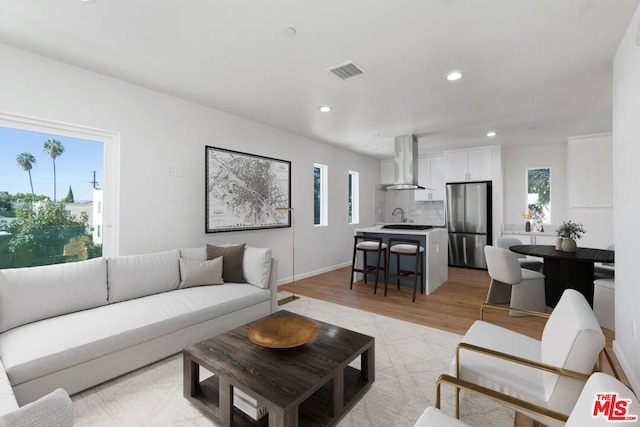 living room with a healthy amount of sunlight and light wood-type flooring