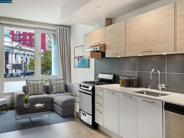 kitchen featuring appliances with stainless steel finishes, backsplash, and sink