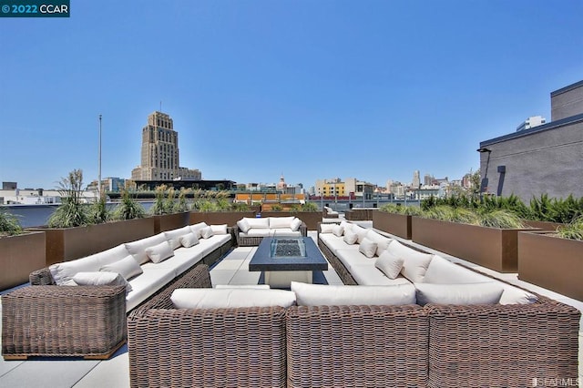 view of patio / terrace with an outdoor living space with a fire pit