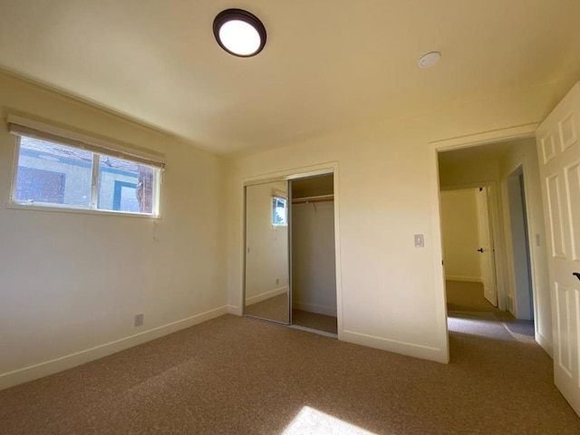 unfurnished bedroom with a closet and dark carpet