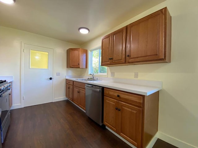 kitchen with dark hardwood / wood-style flooring, sink, and stainless steel appliances