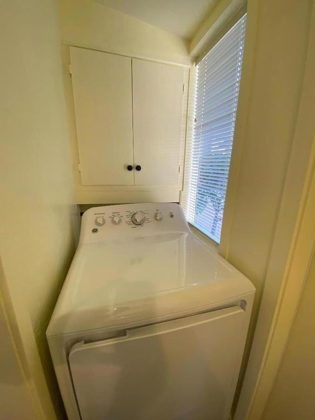 laundry room featuring cabinets and washer / dryer