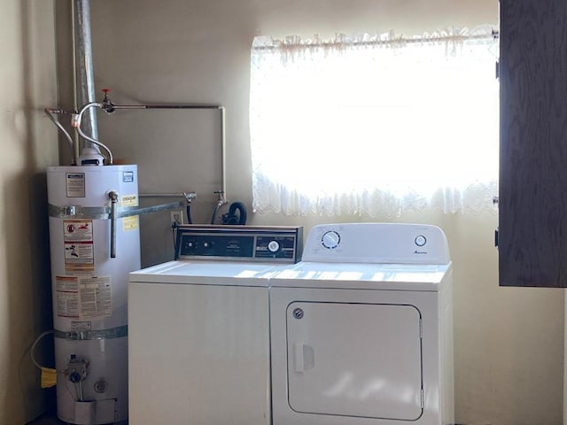 laundry room with washer hookup, washing machine and dryer, and strapped water heater