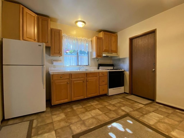 kitchen featuring light tile floors, tile countertops, white appliances, and sink