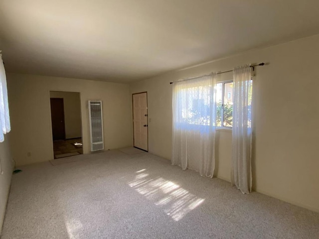 unfurnished room featuring light carpet