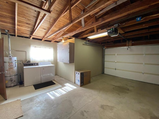 garage featuring separate washer and dryer, a garage door opener, and secured water heater