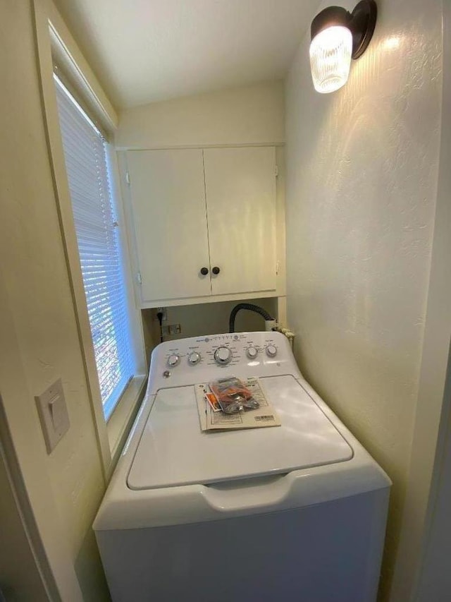 laundry room with cabinets and washer / dryer