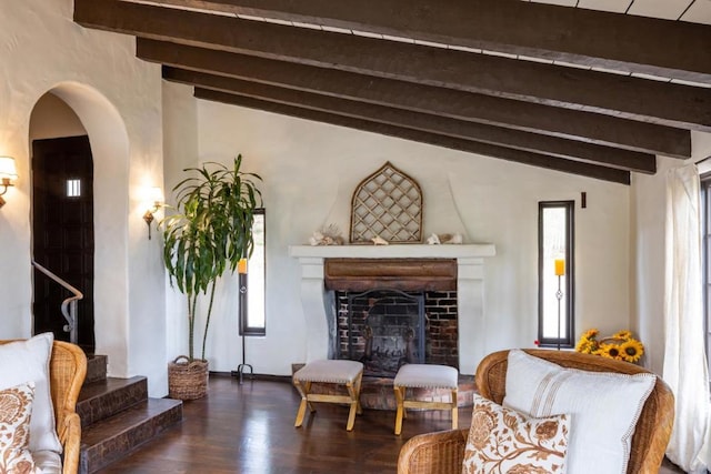 living room with dark hardwood / wood-style floors and vaulted ceiling with beams