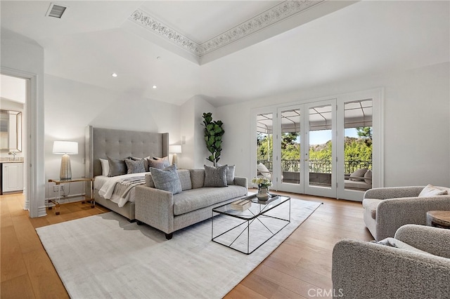 bedroom with french doors, access to exterior, and light hardwood / wood-style flooring