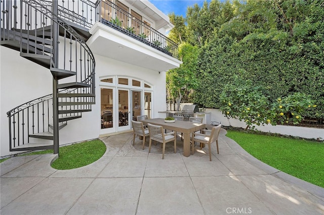 view of patio / terrace featuring french doors, a balcony, and a grill