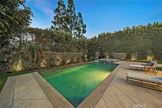 view of swimming pool with a patio and an in ground hot tub