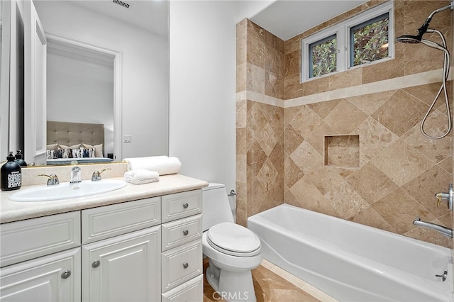 full bathroom featuring toilet, tile floors, tiled shower / bath combo, and oversized vanity