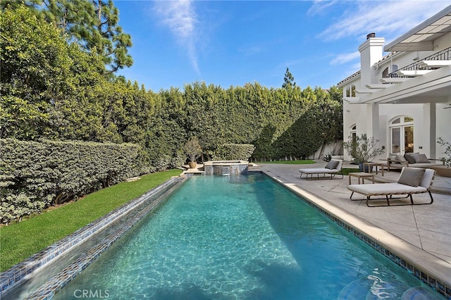 view of swimming pool featuring an in ground hot tub and a patio