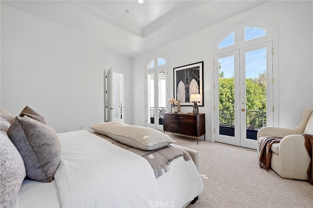 bedroom with light carpet, french doors, access to outside, and multiple windows