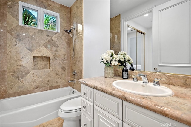 full bathroom featuring toilet, tiled shower / bath combo, and oversized vanity