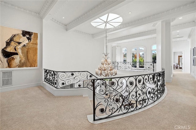 interior space featuring crown molding, an inviting chandelier, light colored carpet, and beamed ceiling