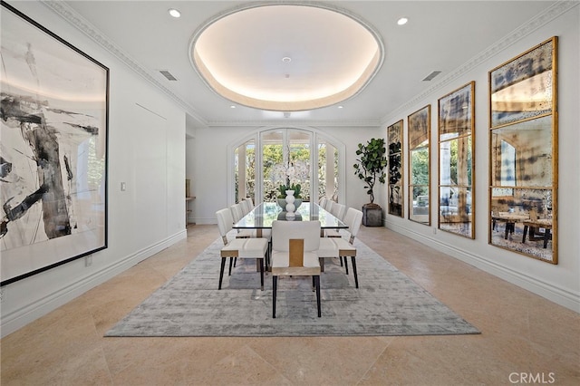 dining area with light tile floors and a raised ceiling