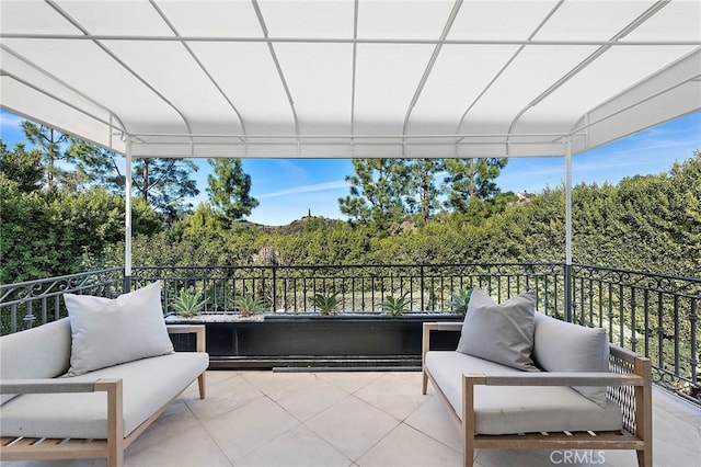 exterior space featuring a balcony and outdoor lounge area