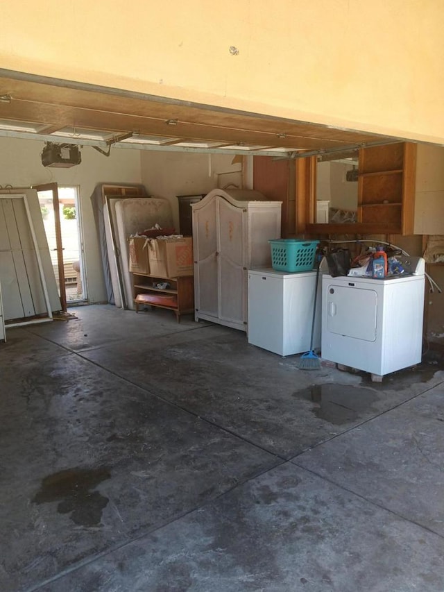 garage with washer / dryer and a garage door opener