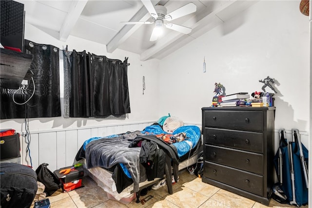 tiled bedroom with ceiling fan and beamed ceiling