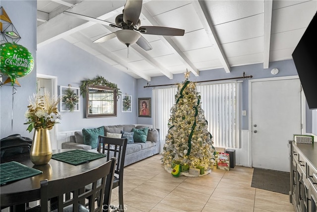 interior space featuring ceiling fan, lofted ceiling with beams, and light tile floors