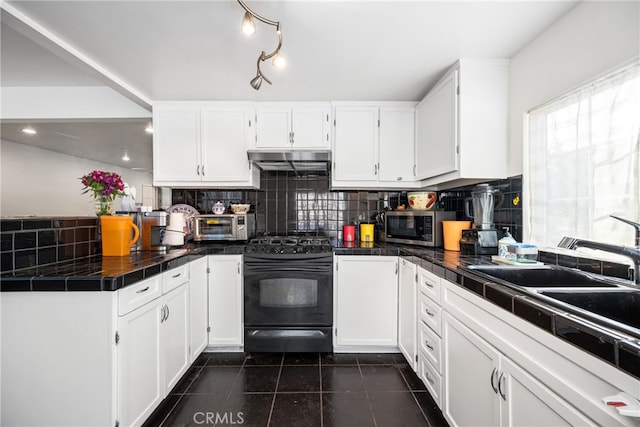 kitchen with dark tile flooring, white cabinets, backsplash, tile counters, and black / electric stove