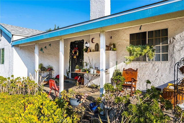 doorway to property featuring a fireplace and a patio