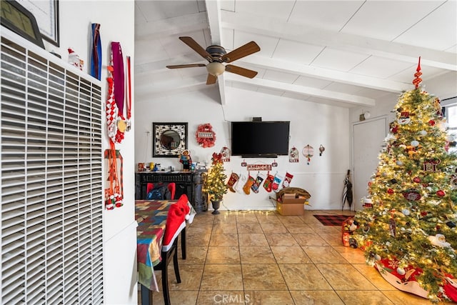 interior space featuring ceiling fan and vaulted ceiling with beams