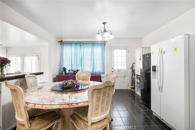 tiled dining area with plenty of natural light and a chandelier