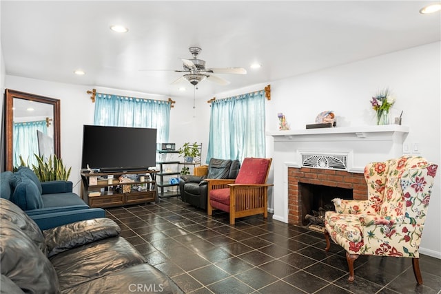 tiled living room featuring ceiling fan and a fireplace