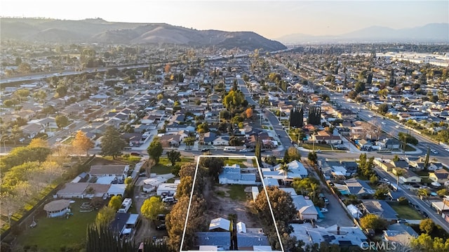 aerial view at dusk featuring a mountain view