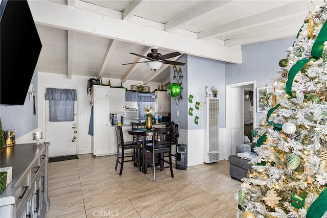 kitchen with beam ceiling, white cabinetry, ceiling fan, and light tile floors