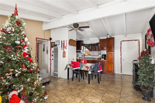 dining room with light tile floors, ceiling fan, and beam ceiling