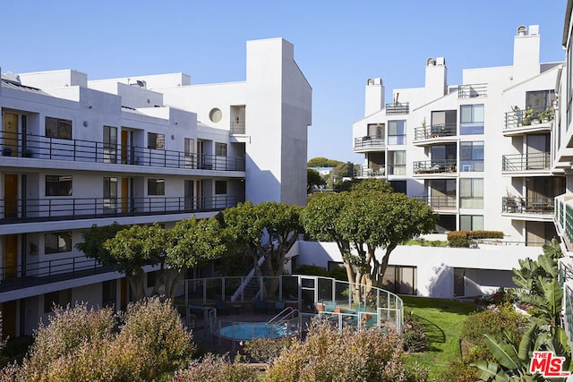 view of building exterior featuring a pool