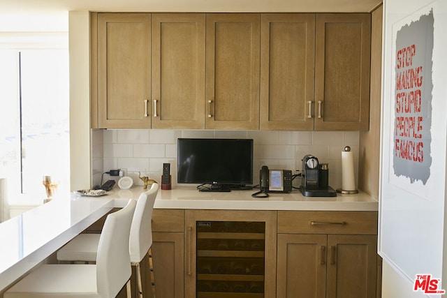 interior space featuring backsplash and beverage cooler