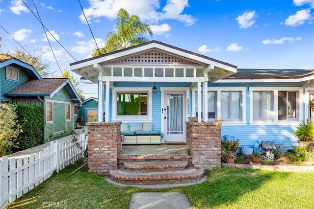 view of front of house with a front yard and covered porch