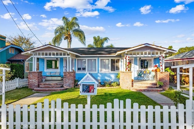 view of front of home featuring a front yard and a porch