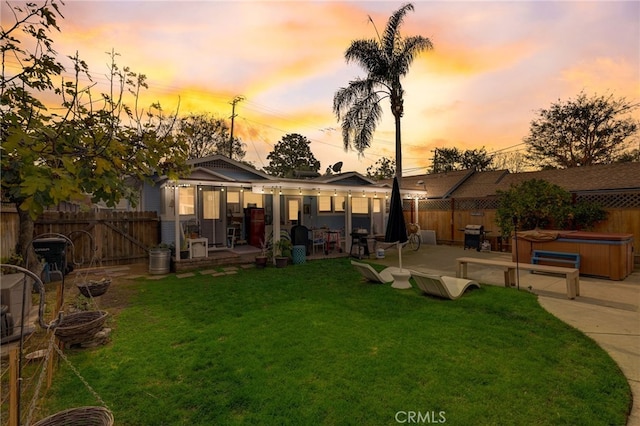 817 E Palmyra Ave, Orange, CA 92866 - back of property at dusk with a hot tub and a patio