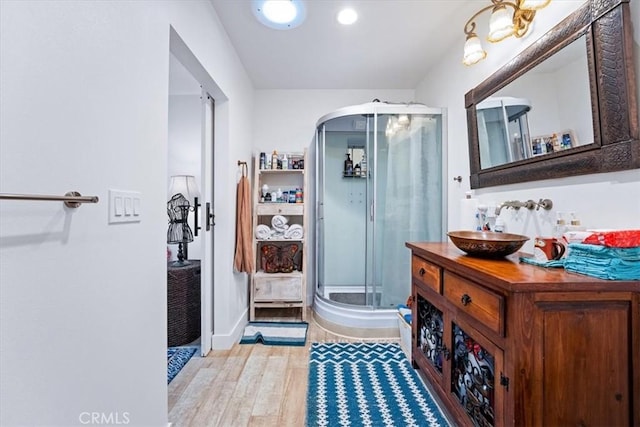 817 E Palmyra Ave, Orange, CA 92866 - bathroom with a stall shower, wood finished floors, vanity, baseboards, and recessed lighting
