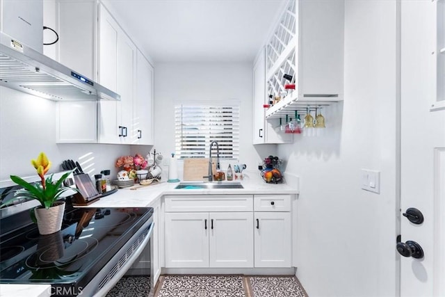 kitchen with stainless steel electric range, sink, white cabinets, and range hood