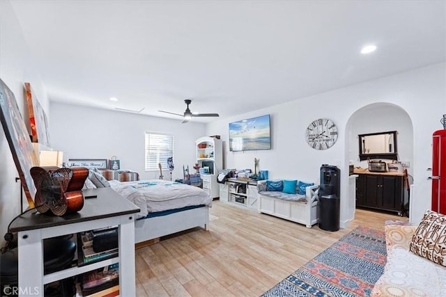 bedroom with ceiling fan and light hardwood / wood-style flooring